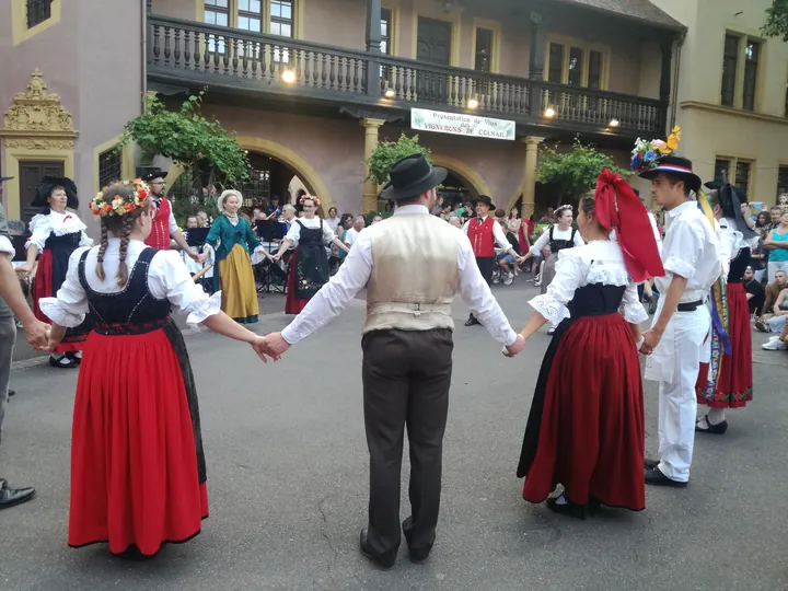 Folklore dancing in the evening at Colmar, Alsace (France)